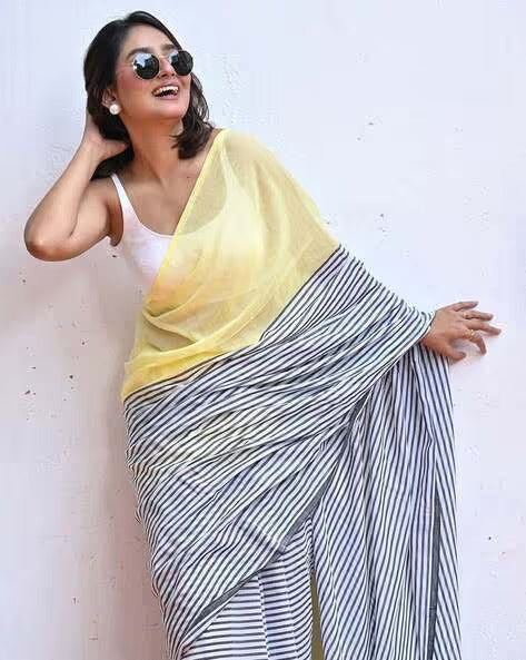 Model wearing Lemon Yellow and Navy Blue Stripe Linen Saree by Swaraas - side view