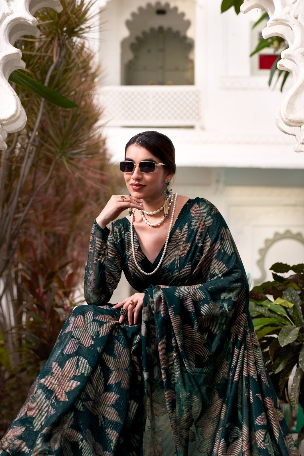 This floral Lurex Brasso saree blends the charm of blooming prints with the luxury of subtle shine