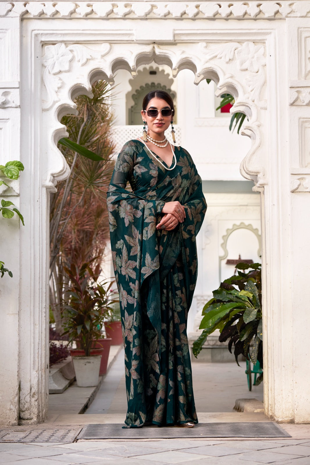 This floral Lurex Brasso saree blends the charm of blooming prints with the luxury of subtle shine