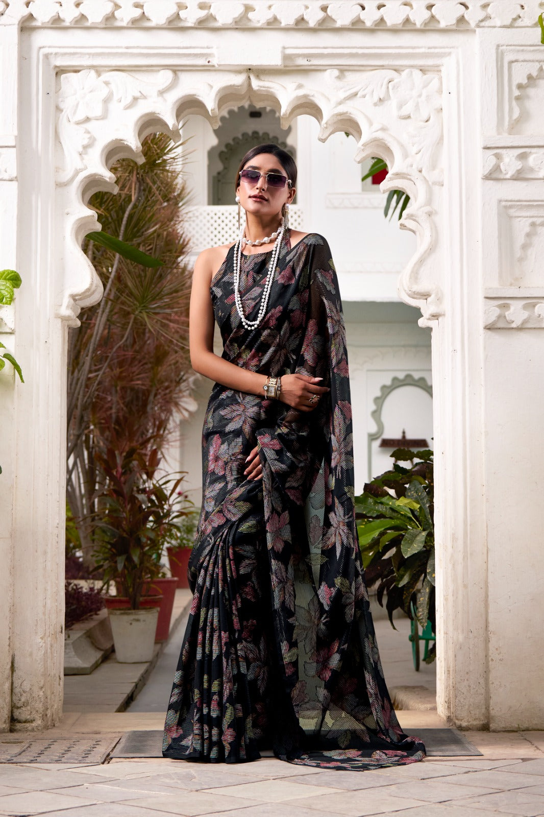This floral Lurex Brasso saree blends the charm of blooming prints with the luxury of subtle shine