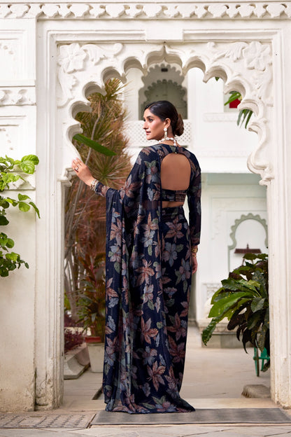 This floral Lurex Brasso saree blends the charm of blooming prints with the luxury of subtle shine