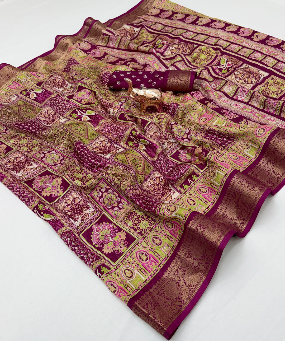 Ivory Dola silk saree spread showing multicolour motifs and gold-tone border