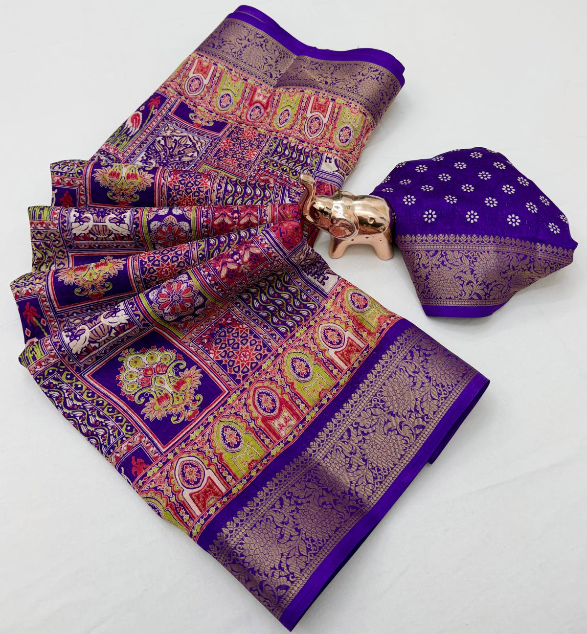 Teal green Dola silk saree spread with ornate border and traditional motifs