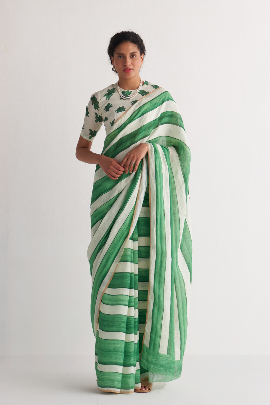 Emerald green and ivory striped linen saree - drape side view