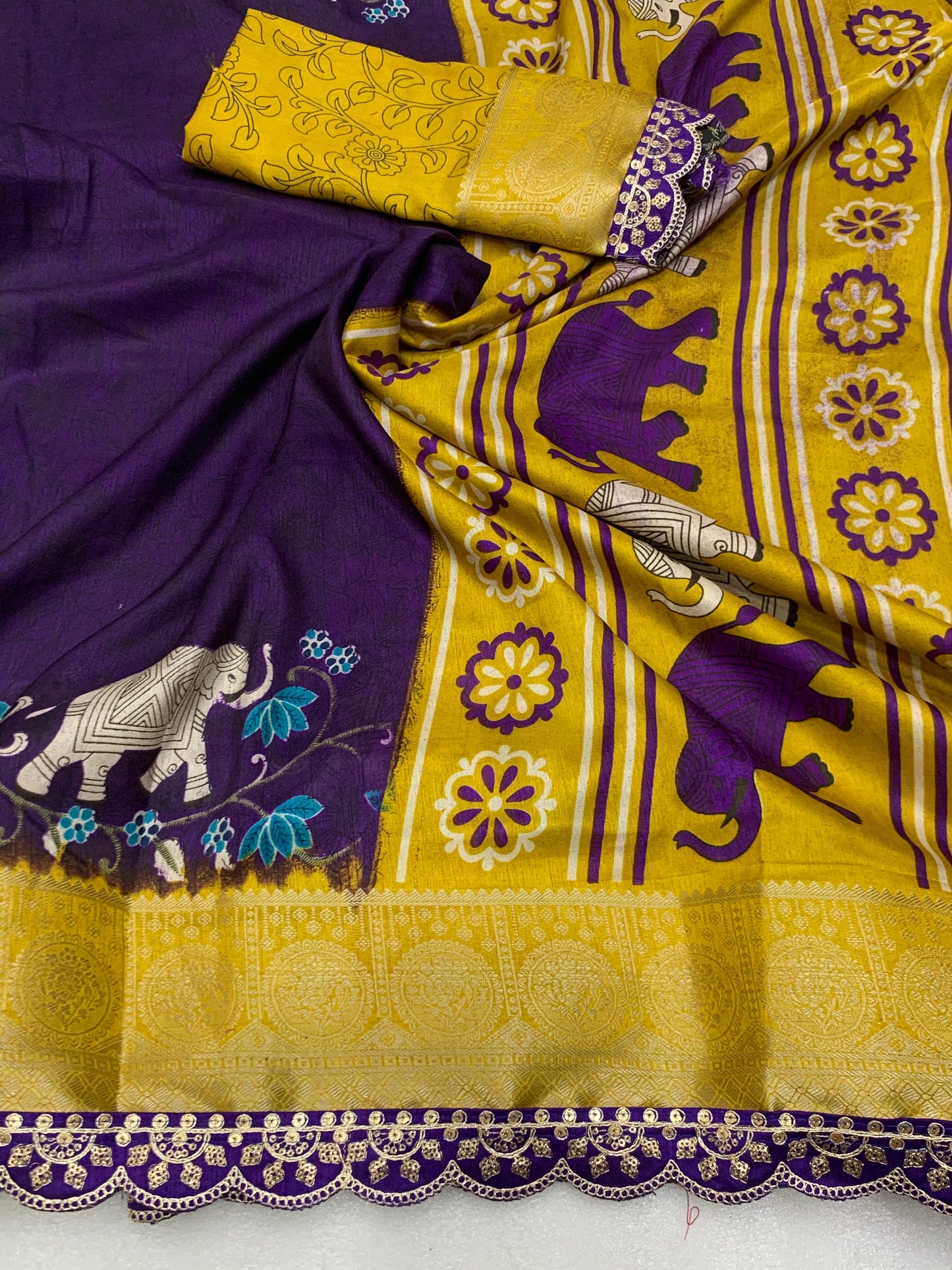 Beautiful Benny crape saree with all over kalamkari design along with scallop maggam work lace at border