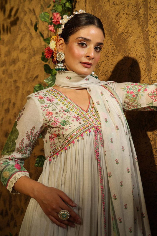 Featuring beautiful MUSLIN ALIA CUT Suit Set which is beautifully decorated with intricate hand embroidery, Zari weaving and prints. It is paired with matching pants and lace dupatta | White - Swaraas