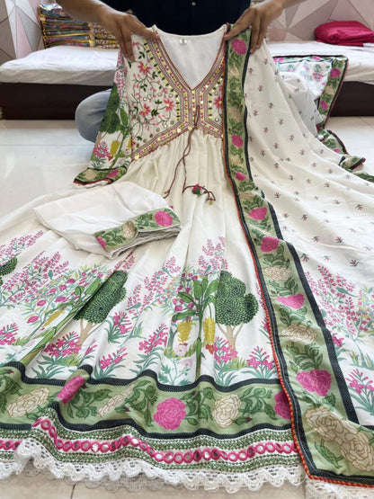Featuring beautiful MUSLIN ALIA CUT Suit Set which is beautifully decorated with intricate hand embroidery, Zari weaving and prints. It is paired with matching pants and lace dupatta | White - Swaraas