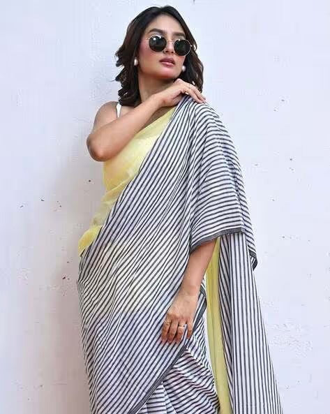 Model wearing Lemon Yellow and Navy Blue Stripe Linen Saree by Swaraas - front view