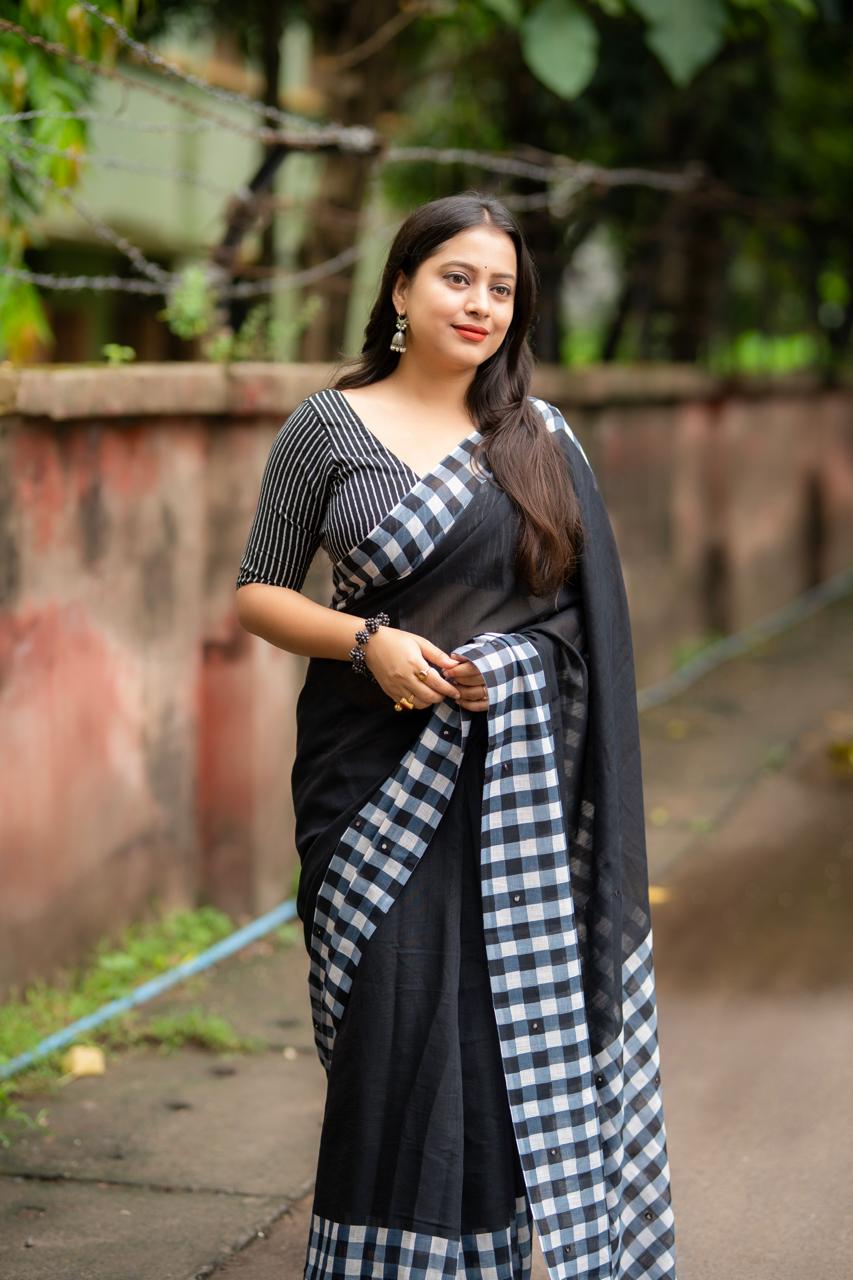 Black linen saree flat lay - fabric detail