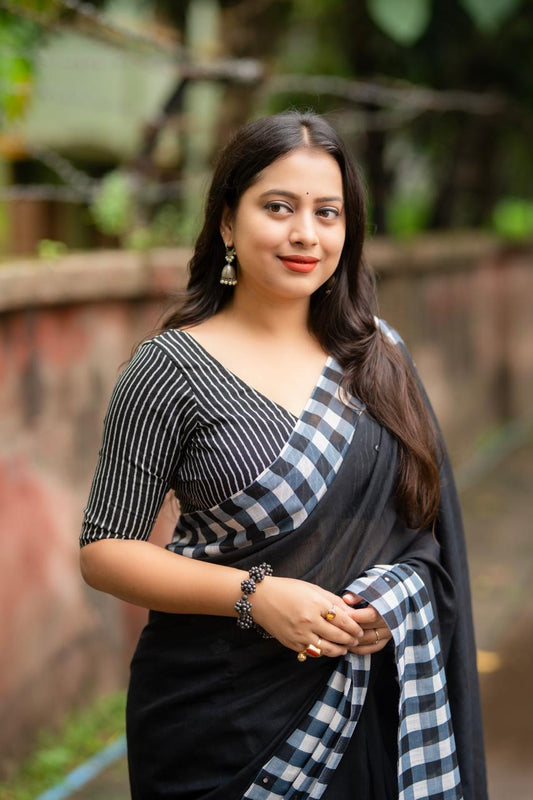 Black linen saree flat lay - pallu detail